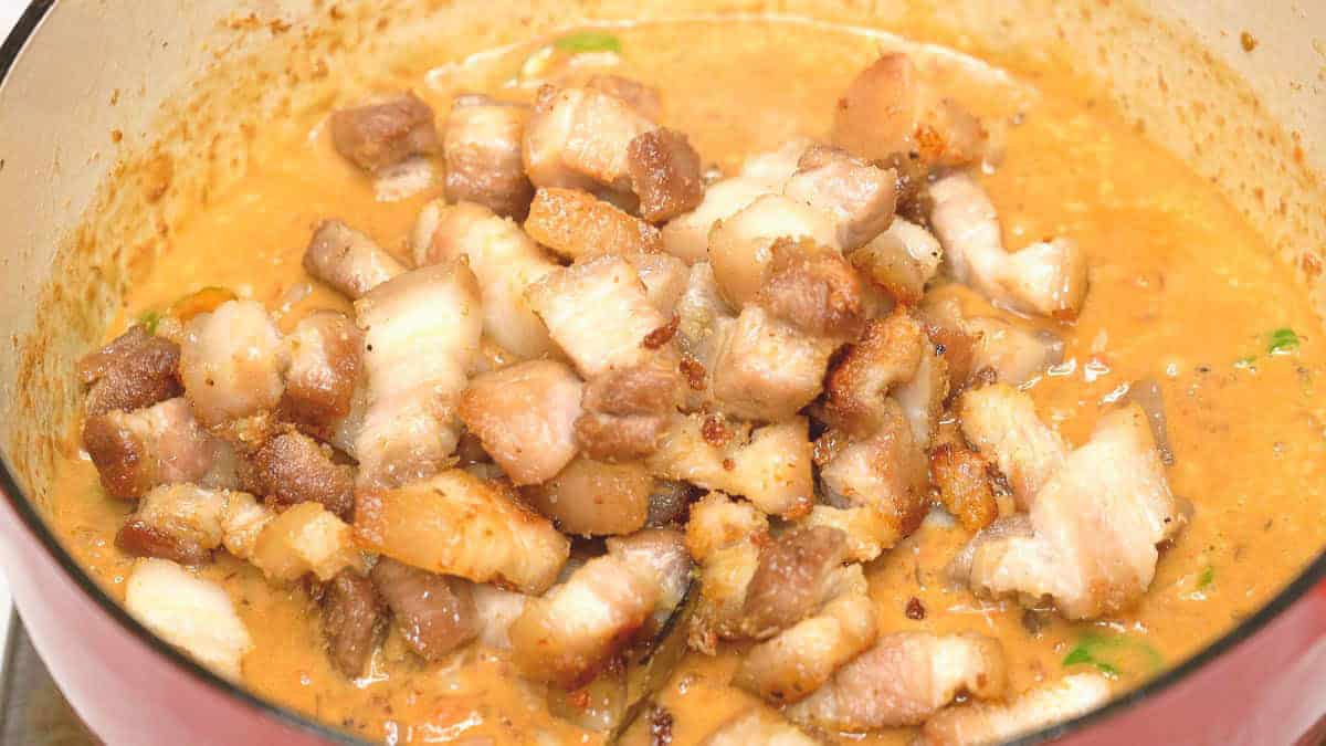 Added the browned meat to the sauce in the pot.
