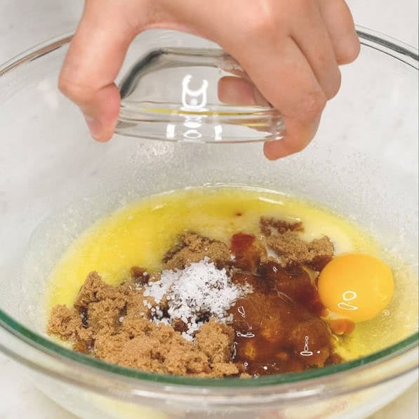 Combining the ingredients in a bowl. Whisking the ingredients in a bowl.