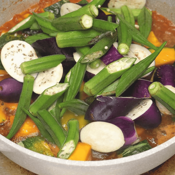 Adding eggplant and okra to the squash.