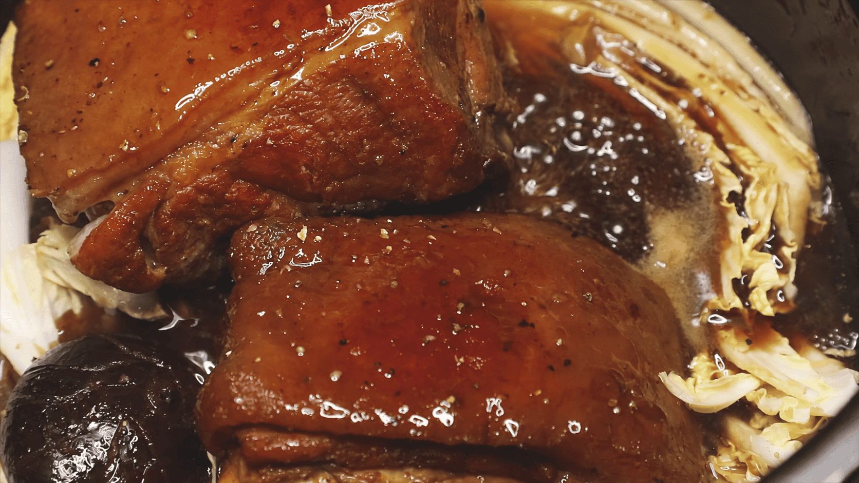 Pork Asado with shiitake mushrooms and napa cabbage in the pot.