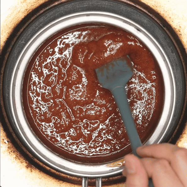 Stirring the caramel sauce with a spatula.
