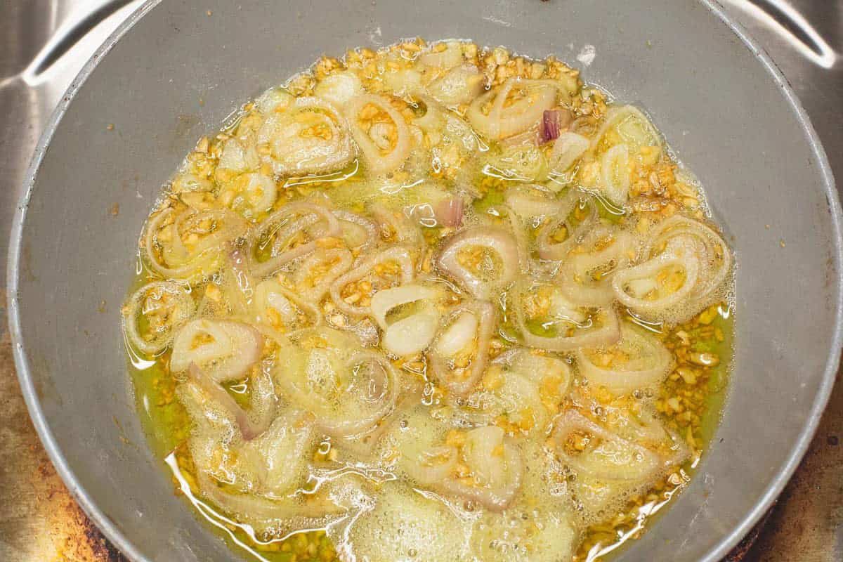 Sauteing the garlic and shallots in the pan.