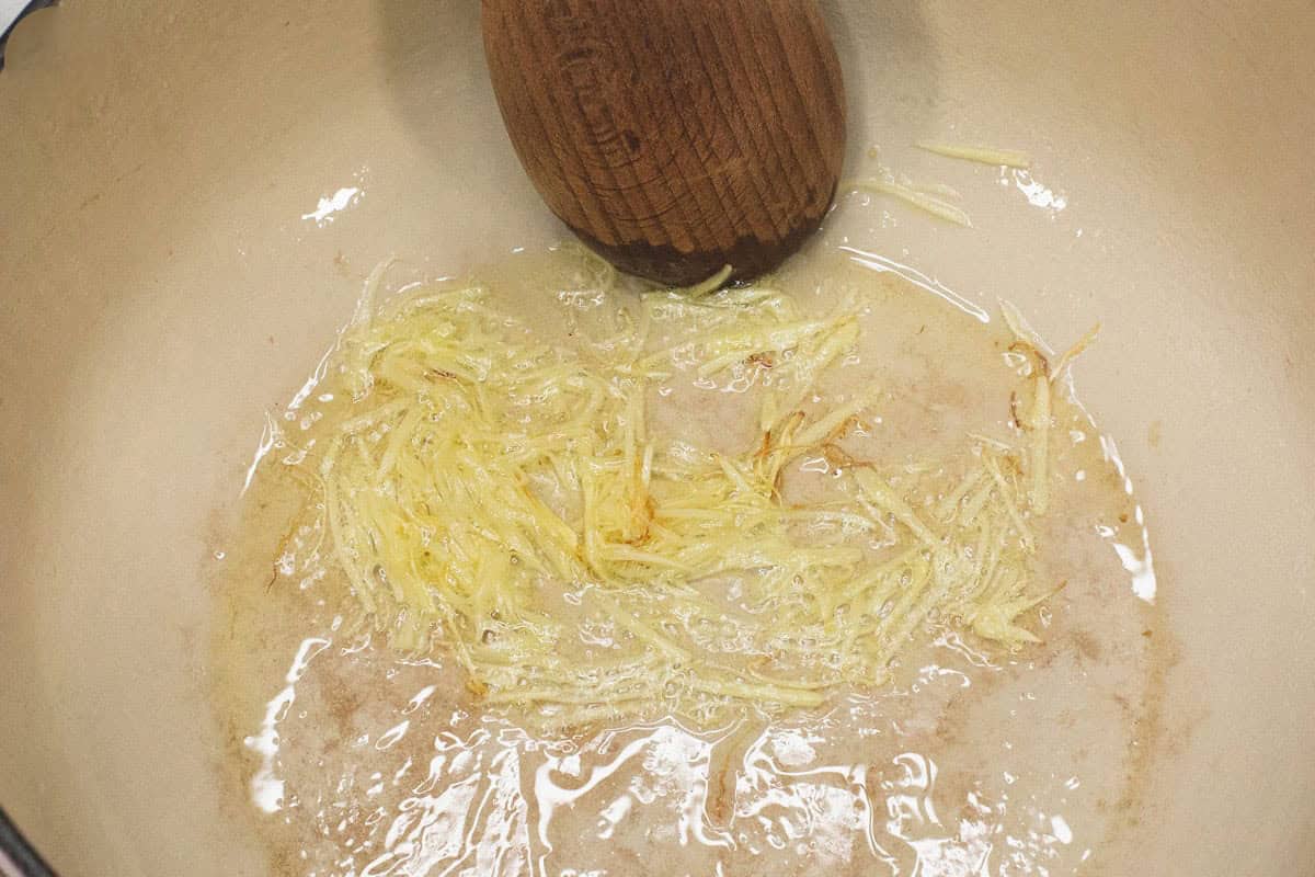 Sauteing ginger in the pot.