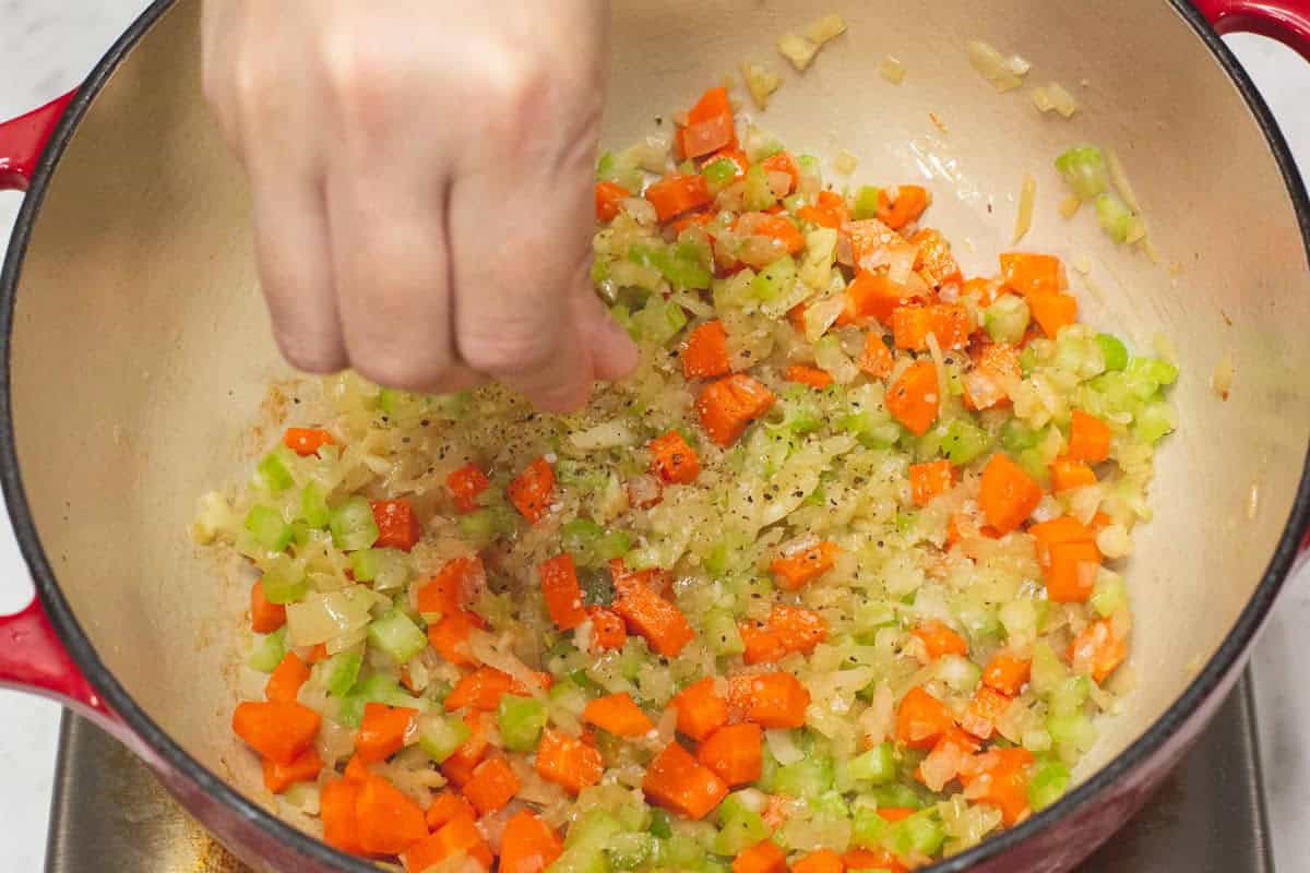 Seasoning the aromatics and vegetables in the pot.
