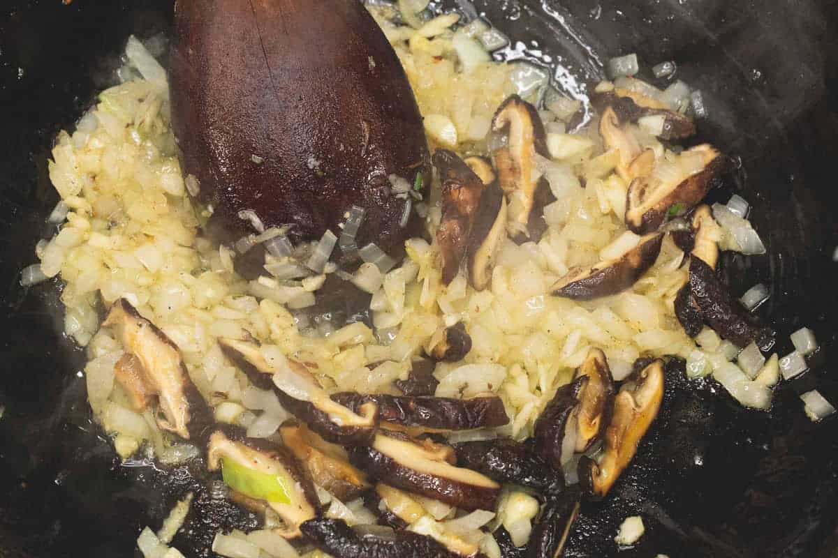 Sauteing the aromatics and shiitake mushrooms in the wok.