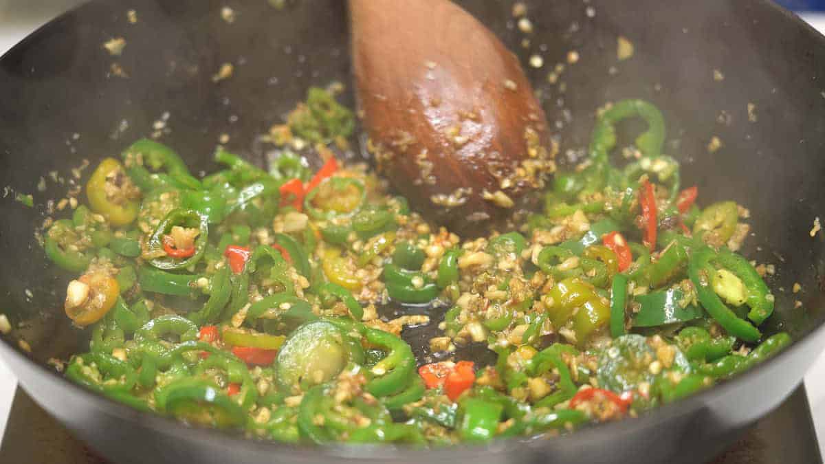 Sauteing the peppers in the wok.