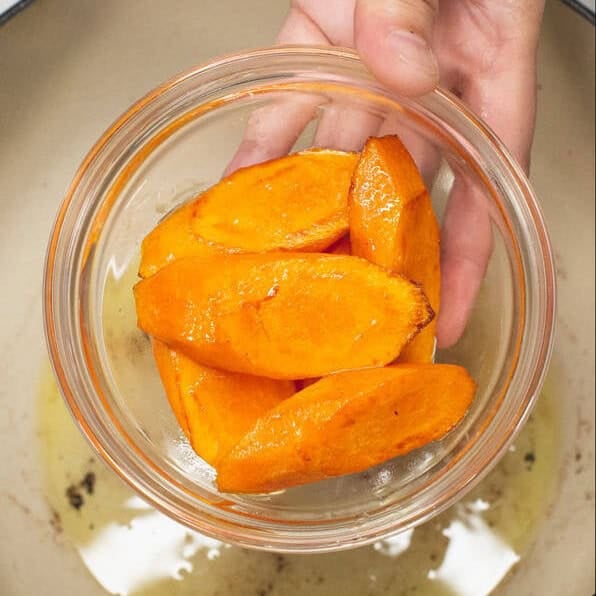 Seared carrots and sweet potatoes in bowls.