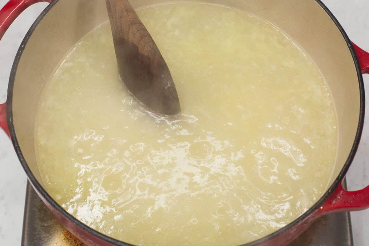 Mixing the lugaw mixture in the pot.