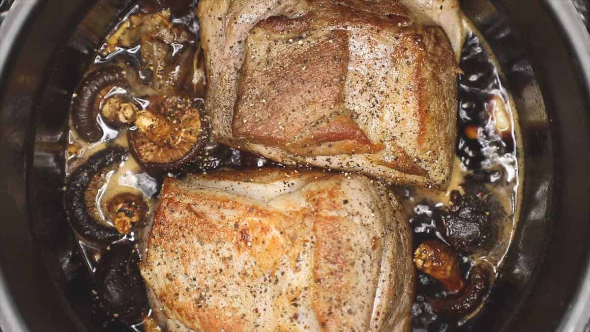 Seared meat and sauce in the pot.