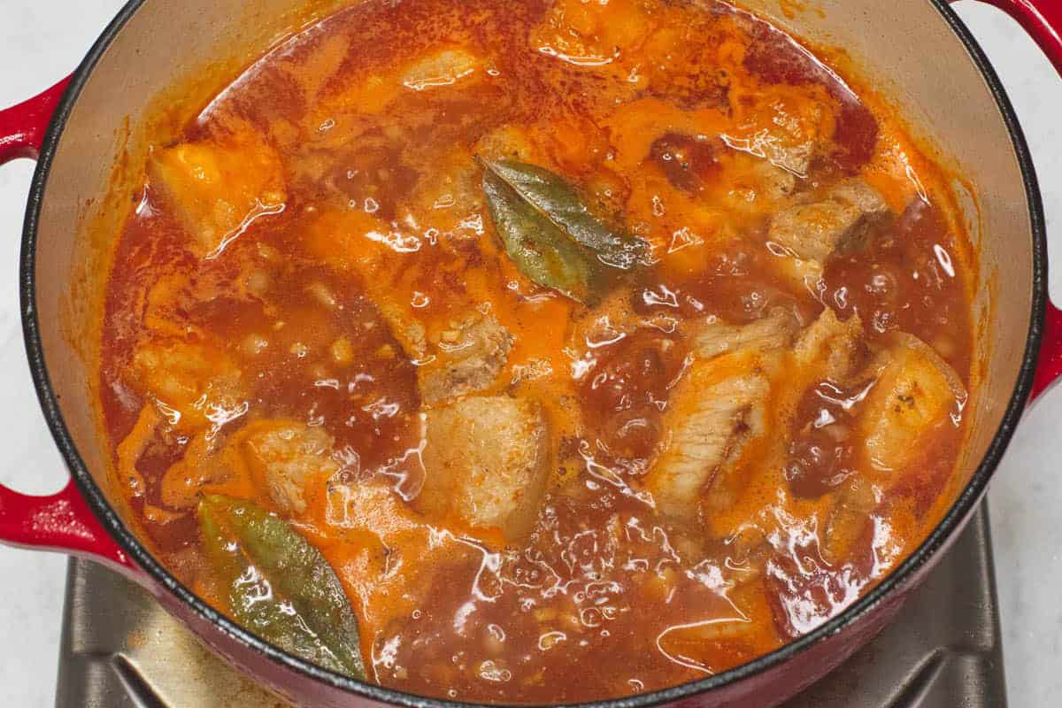 Simmering the meat and other ingredients in the pot.