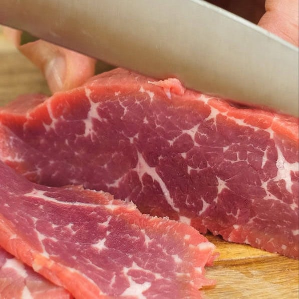 Slicing and marinating the beef.