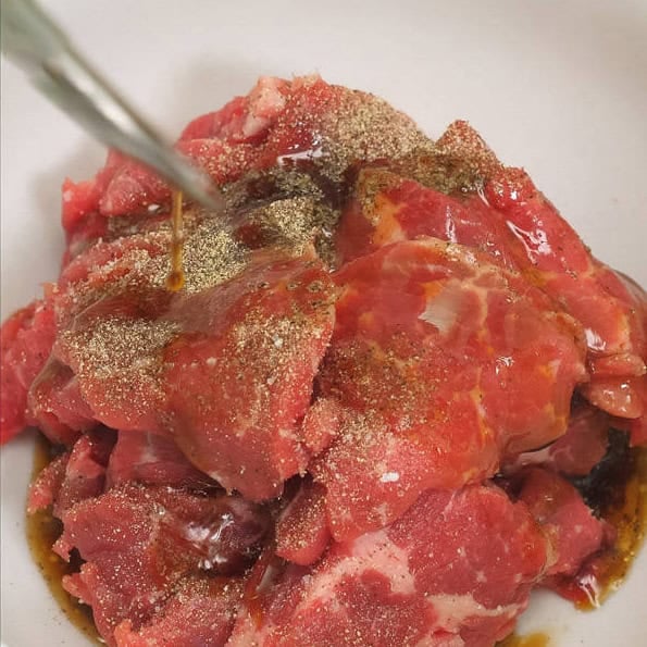 Slicing and marinating the beef.