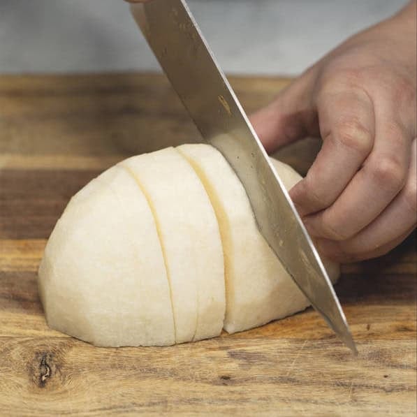 Slicing the jicama and cutting them into sticks.