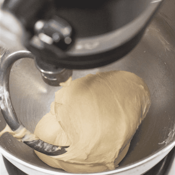 Smooth dough pulling away from the bowl on the dough hook.