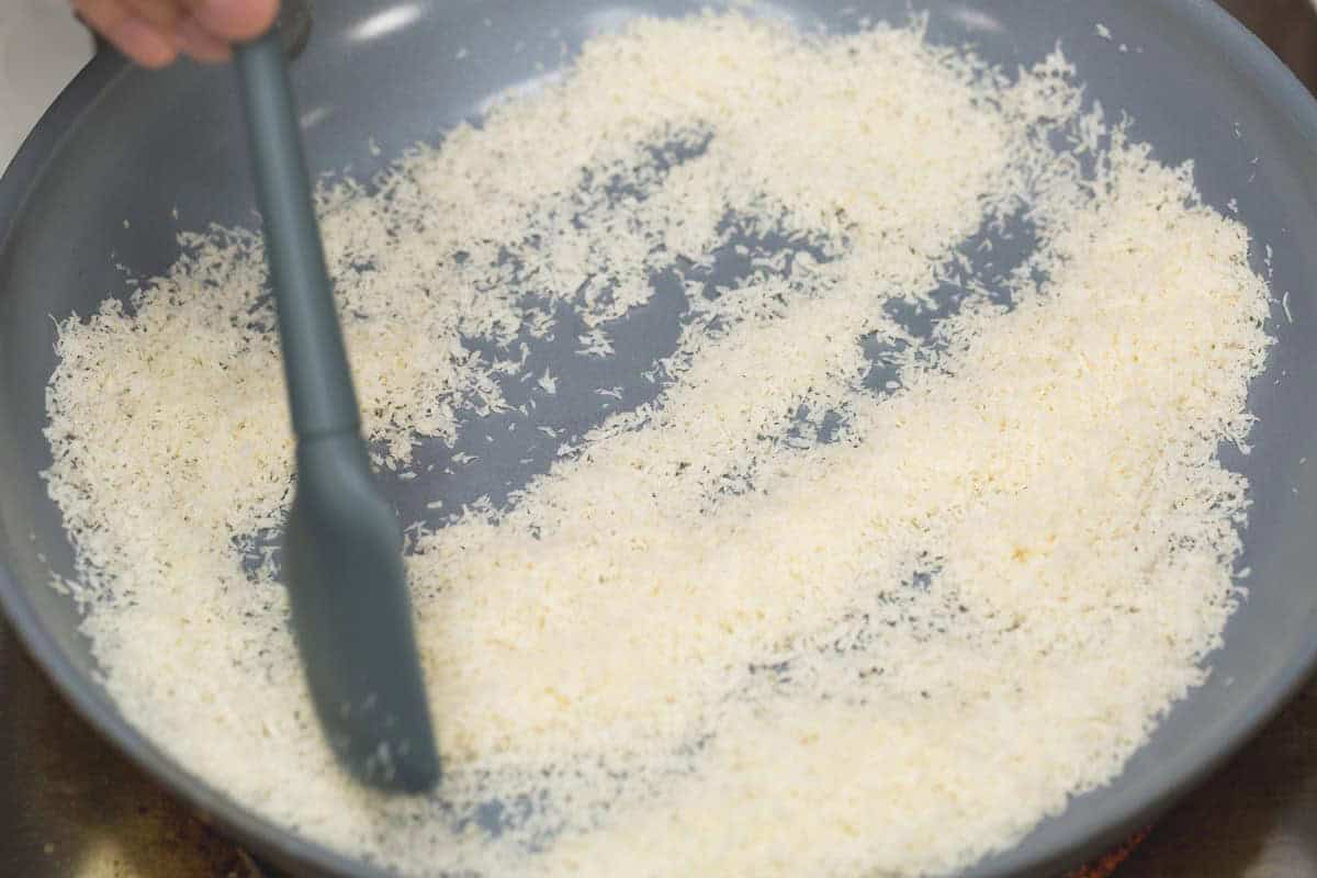 Spreading the coconut evenly in a pan.