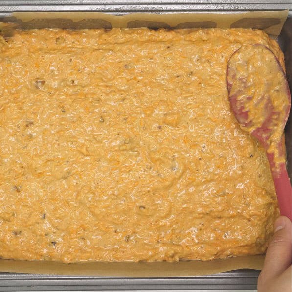 Spreading the cake batter onto the pan. Baked carrot sheet cake in the pan.