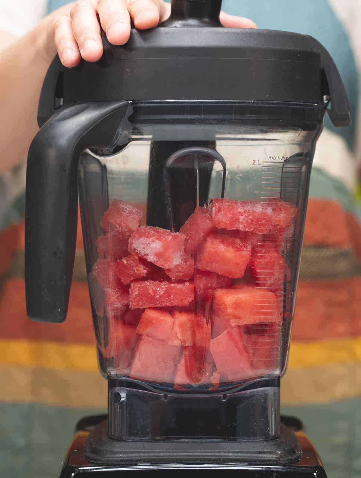 Fresh and frozen watermelon pieces in the blender.
