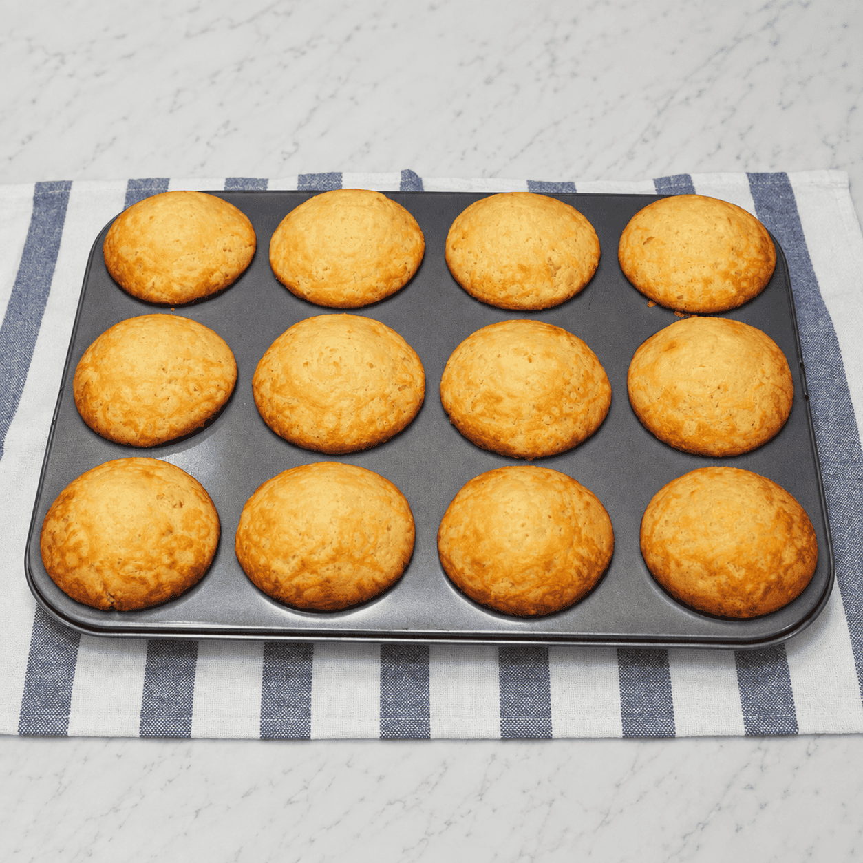 Baked Cheese Cupcakes on a muffin pan.